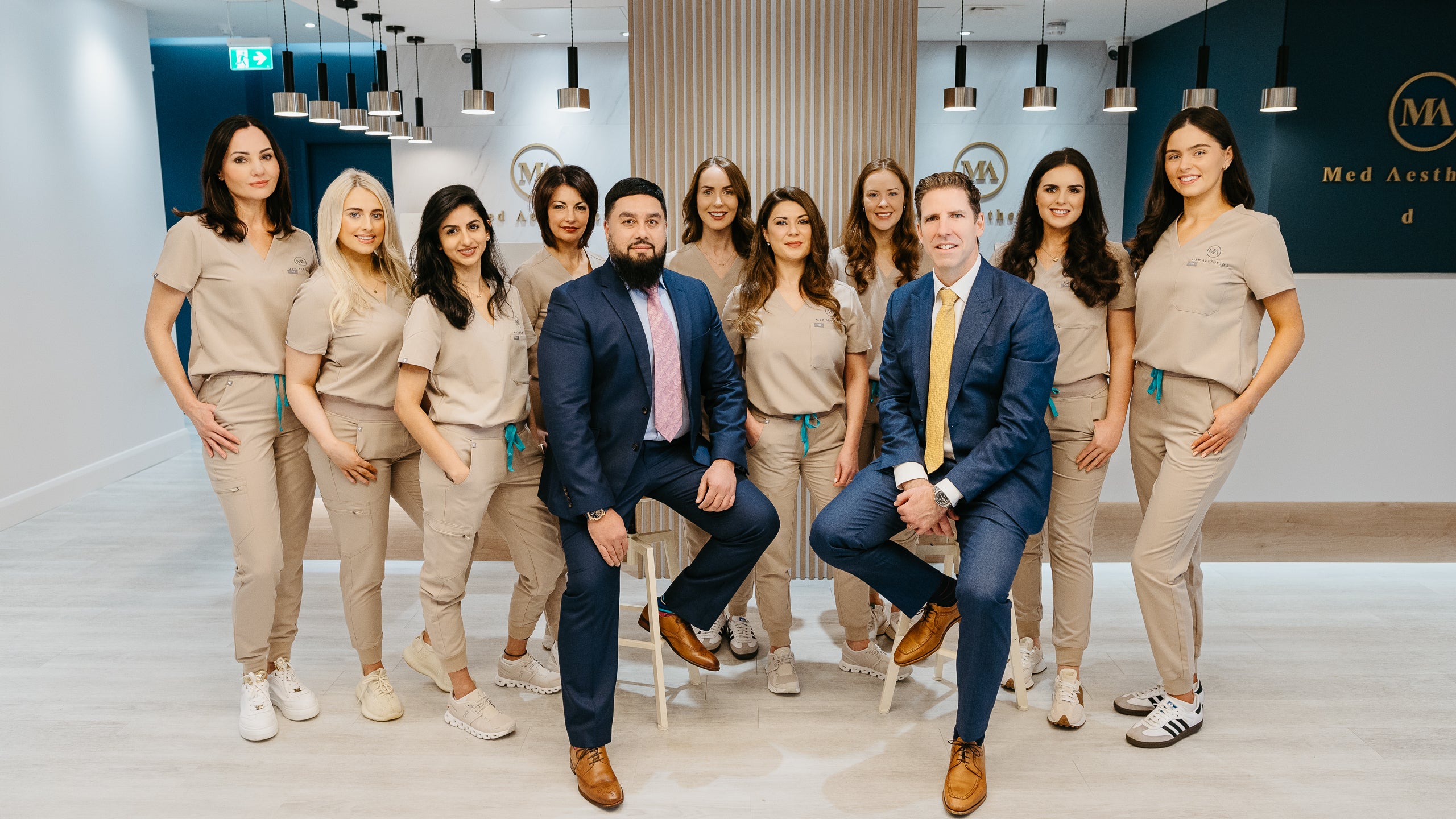 The MedAesthetics team, including Alma McGrath, Mr. Qayyum, Dr. Divya, and Mr. Niall McInerney, posing together in the clinic.