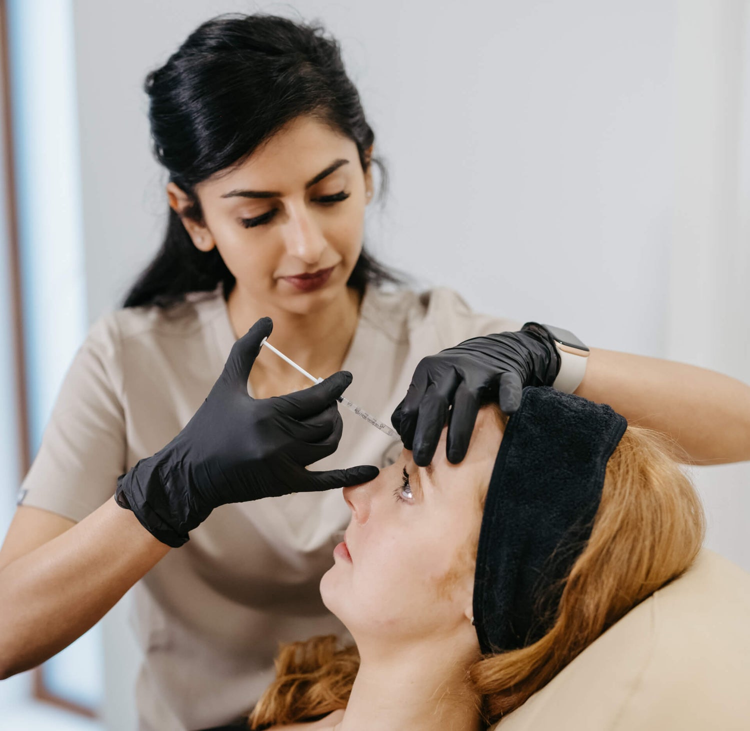 Dr. Divya administering anti-wrinkle injections to a patient at MedAesthetics Galway.